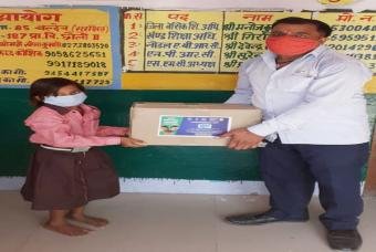 Happiness kit being handed out to an Akshaya Patra mid-day meal beneficiary