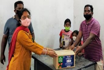 A father helps his children collect a happiness kit