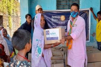 An old lady is relieved at receiving her grocery box