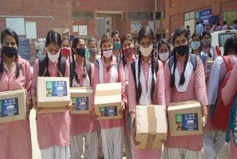 Children pose with their Happiness Kits
