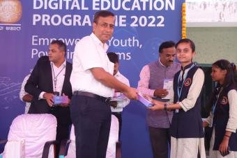 Mr Ravi Kalghatgi - VP (Support Services NTT) is all smiles while distributing the digital tablet