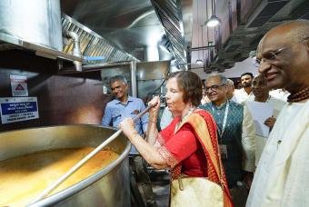 Ms. Linda Thakkar, Vice-Chairman of the Thakkar Family Foundation stirs the dal at the kitchen.