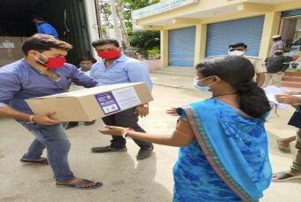 A grocery kit being handed over to a mother.
