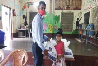 A young girl collects her grocery kit