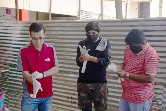 Cargill volunteers gear up to paint blackboards as a team.  